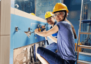 Smiling builders wearing safety gear